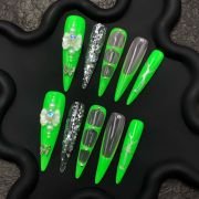 Neon green press-on nails, glow in the dark nails, green butterfly stiletto nails, dramatic long nails
