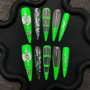 Neon green press-on nails, glow in the dark nails, green butterfly stiletto nails, dramatic long nails
